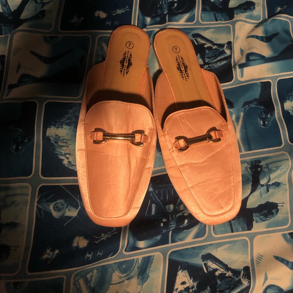 Pink blush loafers with gold detailing on the front